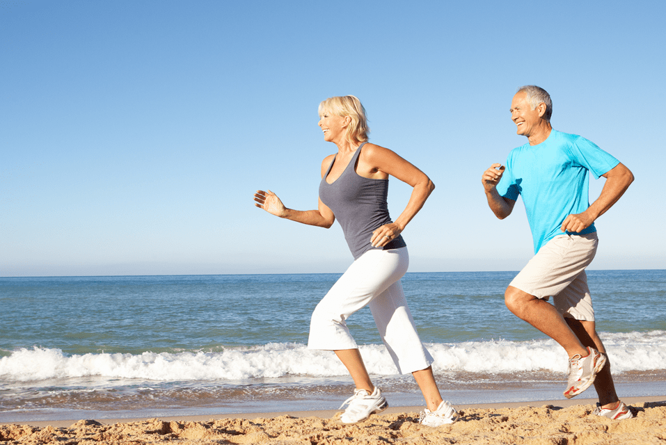 man and woman running on beach