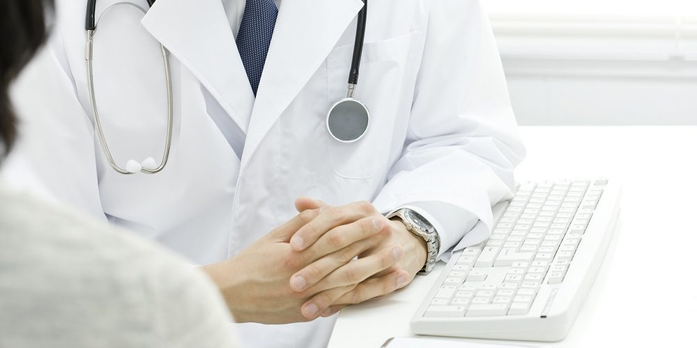 Doctor at table with keyboard