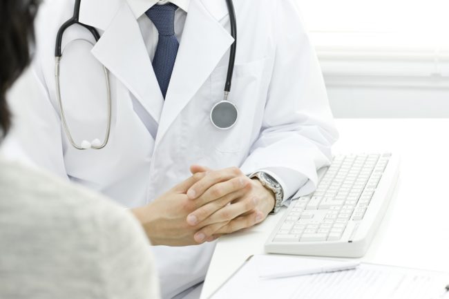 Doctor at table with keyboard