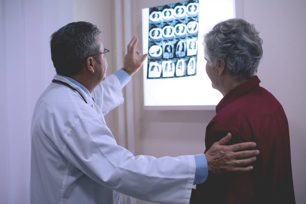 doctor showing patient x-rays