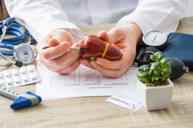 Doctor explaining what alcohol does to the liver.